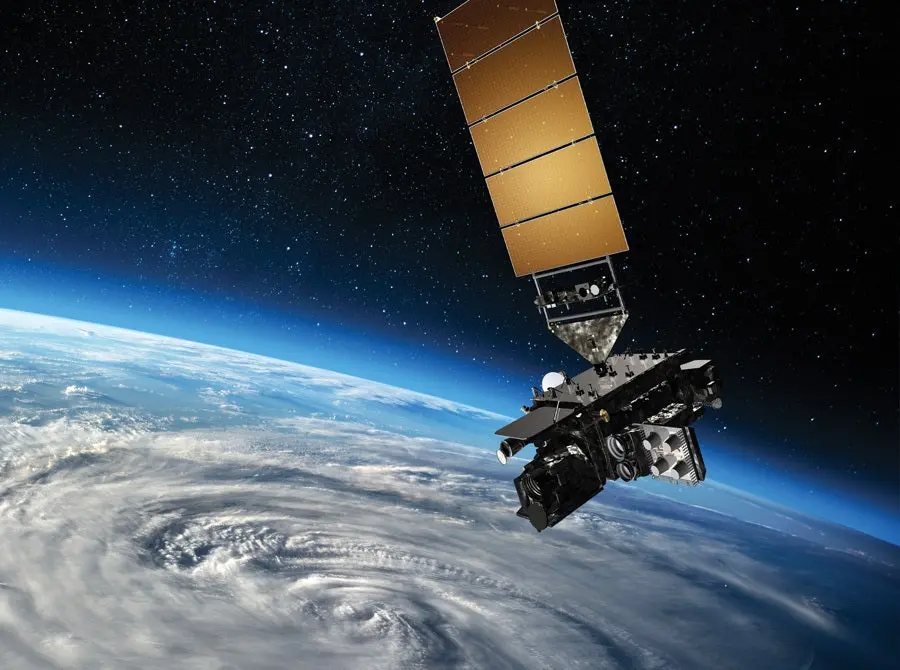 Satellite orbiting above a storm system on Earth